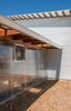 The exterior of the greenhouse is translucent plastic polygal panels screwed to the cedar structure. A thermostat turns on the exhaust fan if it gets too hot during the summer. Photo 11 of The Goat Sheds modern home