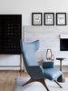 Modern home with Living Room, Chair, and End Tables. The Ondine wing back chair by Vladimir Kagan is the homeowners favorite piece in this room. The sleek lines are reminiscent of the race cars he loves to drive. A Luca drink table by Currey & Co sits beside it. Kelly Wearstler's stunning Dillion Cabinet sits just behind it. Photo 2 of Contemporary Cool Sausalito Bachelor Pad