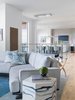 Modern home with Living Room, Sofa, Pendant Lighting, Sectional, and End Tables. Triggs designed a custom sectional with a 45-degree angle to take in multiple views in this living room. An angular Drip Fold table by Noble Goods sits to the side. Hand-dripped with liquid resin, no two are exactly alike. Photo 3 of Contemporary Cool Sausalito Bachelor Pad