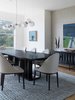Modern home with Dining Room, Table, Pendant Lighting, Chair, and Storage. "The Welles chandelier is another striking piece in the room. It had just been introduced in glass when I was working on this project, which was perfect as we didn't want a heavy piece that could block the views. It was also important for the fixture to be linear, not vertical, as this space is opposite a vertically hung waterfall chandelier in the entry." Photo 5 of Contemporary Cool Sausalito Bachelor Pad