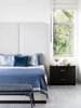 Modern home with Bedroom, Night Stands, Bench, Pendant Lighting, and Bed. "For the master bedroom we wanted to create a mood that was both romantic and masculine. We continued the palette of soft blues, grays and creams to create this balanced aesthetic. The ceilings were 10 feet tall with long and narrow windows, so we needed the bed to have a tall headboard to anchor the space and feel in harmony with the windows. We chose the Vibia slim pendants for the bedside lighting as they reminded me of ones you'd find in a luxurious, high end hotel end and I wanted that vibe for my client's bedroom. The pendants are masculine and refined. They're very cool but not at all overbearing." Photo 8 of Contemporary Cool Sausalito Bachelor Pad
