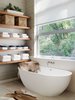 Modern home with Bath Room and Freestanding Tub. "For the walls in the master bath, I chose a textural Phillip Jeffries wall covering from De Sousa Hughes as I wanted to soften the room and make it feel less cold. I love how the textured element warms up the space." Photo 9 of Contemporary Cool Sausalito Bachelor Pad