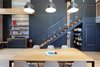 Modern home with Dining Room, Chair, Shelves, Pendant Lighting, Table, Storage, and Light Hardwood Floor. For the dining area, Murdock called on local furniture designer Ohio Design to create a semi-custom white oak table. She added Eames chairs for a clean and crisp modern aesthetic. Matte black walls and appliance panels provide a moody juxtaposition with the brick and wooden elements.
Storage solutions were also a key element of each room's design. "The client expressed a real desire to make a proper space for everything and no detail was overlooked in designing storage solutions," Murdock adds. Photo of Details Make the Difference in this San Francisco Urban Loft