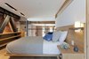 Modern home with Bedroom, Wall Lighting, Bed, Wardrobe, Recessed Lighting, Light Hardwood Floor, Storage, and Night Stands. Above the great room lies the bedroom where Murdock designed an integrated oak headboard, nightstand and open closet system to free up as much space as possible. "The open closet was previously buried unused space with a gyp wall concealing the beauty beyond, but its installation was an engineering and installation feat! The angled beams with rounded edges were another challenge that made it difficult to install the floating shelves. In the end, the installation looks effortless thanks to Jeff and his fantastic team", Murdock adds. Photo 9 of Details Make the Difference in this San Francisco Urban Loft