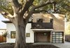 Modern home with Exterior, Wood Siding Material, Flat RoofLine, Stucco Siding Material, and Stone Siding Material. One of the most significant challenges was designing to accommodate and celebrate a 100-year old heritage tree that was centrally located on the site. Finding a way to preserve this 60’ tall and 50’ wide Coast Live Oak while creating four new housing units was no small feat. According to Young, “One of the biggest fears expressed by the neighbors was that the heritage tree would be removed. To preserve it, we broke the massing of the four units into two separate buildings. We wanted the front building and single-family home to nestle under the limbs so one of the first things we did was build a 3D model of the tree and its major limbs and branches. By working with the arborist to prune some of the secondary branches, we were able to open up the canopy to bring more light to the yard and tuck the single-family home and the 3rd floor terrace under the primary limbs.” Photo 4 of Modern Multi-Family Architecture