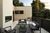 Modern home with Outdoor, Concrete Patio, Porch, Deck, Horizontal Fences, Wall, and Wood Fences, Wall. Privacy considerations also played a big part in the overall design. "The plans were designed to give each unit generous exterior terraces and balconies opening out from the main living area to create large indoor/outdoor spaces. We preserved the privacy of these spaces by using wood slat partitions as both low height and full height screening elements on all sides of the building. This gave the tenants a sense of safety and privacy from their neighbors both on and off site while still allowing for some visual transparency. The main terrace for each unit is located on a different facade, further enhancing the privacy of each unit," adds Young. Photo 5 of Modern Multi-Family Architecture