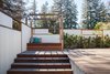 A daybed on an enclosed, private terrace offers a spot to relax outside of the master suite. The windows slide open for a view, and close for more privacy and shade. By Arterra Landscape Architects Photo 8 of Talk of the Neighborhood modern home