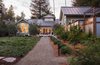 The home wraps around the landscape, and its many windows open to garden, blurring the line from inside to out. By Arterra Landscape Architects Photo of Talk of the Neighborhood modern home