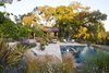 Looking south at sunset, the rustic pool house sits quietly in a stand of great oaks.
The building, pool and terraces are all sited to protect and celebrate the oaks and maximize views.
By Arterra Landscape Architects. Photo by Michele Lee Willson Photo 4 of Homestead on Whiskey Hill modern home