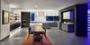 Modern home with Kitchen, Engineered Quartz Counter, Ceramic Tile Floor, White Cabinet, Wood Cabinet, Accent Lighting, Recessed Lighting, Cooktops, Wall Oven, Range Hood, Wine Cooler, and Drop In Sink. Kitchen and Dining from Patio: the Wine display room is at right. Photo of the Duncan Residence