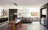 Modern home with Kitchen, Engineered Quartz Counter, Wood Cabinet, Porcelain Tile Floor, Colorful Cabinet, Ceiling Lighting, Recessed Lighting, Accent Lighting, Undermount Sink, Wall Oven, and Refrigerator. View of Dining Room and Kitchen Photo 13 of the Duncan Residence