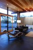 Integral color concrete floors below, and birch soffits above, extend to the exterior breaking the conventional opaque boundary, blurring the line between interior and exterior. A large custom sliding door can be opened to strengthen the connectivity with the exterior spaces. Photo 3 of The Silvertree Residence modern home