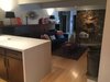 Modern home with Kitchen, Wood Cabinet, Engineered Quartz Counter, Light Hardwood Floor, Ceramic Tile Backsplashe, Ceiling Lighting, Refrigerator, Range Hood, Microwave, Dishwasher, Wall Oven, Cooktops, and Drop In Sink. Fireplace room Photo 8 of Disco 3332 in Dallas, TX
