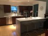Modern home with Kitchen, Engineered Quartz Counter, Wood Cabinet, Light Hardwood Floor, Refrigerator, Ceramic Tile Backsplashe, Recessed Lighting, Wall Oven, Dishwasher, Microwave, Cooktops, Range Hood, and Drop In Sink. Kitchen Photo 14 of Disco 3332 in Dallas, TX