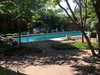 Modern home with Outdoor, Back Yard, Grass, Gardens, Lap Pools, Tubs, Shower, Trees, Wood Patio, Porch, Deck, Large Patio, Porch, Deck, Pavers Patio, Porch, Deck, Wood Fences, Wall, and Landscape Lighting. Dip at Disco 3332 Day view Photo 18 of Disco 3332 in Dallas, TX