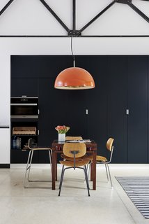 Sleek black cabinetry contrasts beautifully with the home's richly textured wood accents.