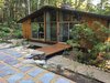 Modern home with Outdoor, Walkways, Back Yard, Garden, Trees, Woodland, Shrubs, Wood Patio, Porch, Deck, Small Patio, Porch, Deck, Decking Patio, Porch, Deck, Hardscapes, and Stone Patio, Porch, Deck. Exterior terrace, water channel, deck and window wall Photo 9 of Architect's own Home