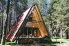 Modern home with Exterior, Cabin Building Type, A-Frame RoofLine, Metal Siding Material, Metal Roof Material, Tiny Home Building Type, and Wood Siding Material. Tucked away in California’s Sierra National Forest, this remote and rentable vacation home has a cozy interior that embraces outdoor views. Photo of The Red A-Frame
