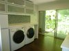 A 10 foot wide sliding glass door opens to a balcony. It provides fantastic natural light, and ties the room in with the natural greens from the surrounding mature woods. Photo 5 of Modern Laundry, Pantry and Dog Room modern home