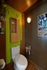 The strand-woven bamboo stretches up the wall & swings overhead; concealing lighting & an exhaust fan. An eco-flush Toto toilet is also featured. Photo by: Black Olive Photographic Photo 14 of SMITH Kitchen modern home
