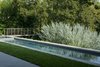 Projecting over the top of the existing slope, the lap pool and spa add valuable real estate to the shallow upper terrace adjacent to the home. Photo 2 of Pasadena Hillside modern home