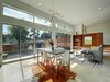 Modern home with Windows and Sliding Window Type. Wall of transom windows above large sliding doors, integrating interior with outdoor space. Photo 6 of KRDB Swede Hill Modern