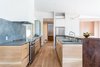 View of kitchen from dining area - a mix of cabinet types was used. The black oak cabinets came from trees grown on my father's property that he milled himself. Photo 4 of Good Haus modern home