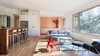 Late afternoon light filtering into the open living, dinning, kitchen area Photo 6 of Good Haus modern home