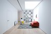 Modern home with Living Room, Ceiling Lighting, Light Hardwood Floor, Bookcase, Chair, Floor Lighting, Shelves, Sofa, and Lamps. Upper Living and Skylight Photo 2 of A House in Yarmouk