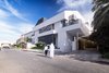 Modern home with Outdoor, Grass, Raised Planters, Trees, Front Yard, Planters Patio, Porch, Deck, Stone Patio, Porch, Deck, Horizontal Fences, Wall, and Landscape Lighting. Street View Photo 9 of A House in Yarmouk
