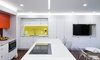 Modern home with Kitchen, Colorful Cabinet, Microwave, Medium Hardwood Floor, Cooktops, Recessed Lighting, Ceramic Tile Backsplashe, Ceiling Lighting, Undermount Sink, Dishwasher, Accent Lighting, Engineered Quartz Counter, White Cabinet, and Wall Oven. View of Kitchen area Photo 11 of DC Waterfront Residence