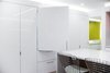 Modern home with Kitchen, Recessed Lighting, Engineered Quartz Counter, Medium Hardwood Floor, White Cabinet, Ceramic Tile Backsplashe, Refrigerator, Accent Lighting, Colorful Cabinet, and Undermount Sink. View of concealed refrigerator Photo 12 of DC Waterfront Residence