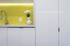 Modern home with Kitchen, Recessed Lighting, Colorful Cabinet, Medium Hardwood Floor, Dishwasher, White Cabinet, Engineered Quartz Counter, Undermount Sink, Ceramic Tile Backsplashe, and Accent Lighting. Detail view of Sink Alcove Photo 4 of DC Waterfront Residence