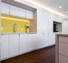 Modern home with Kitchen, Recessed Lighting, Engineered Quartz Counter, Ceiling Lighting, Medium Hardwood Floor, White Cabinet, Accent Lighting, Undermount Sink, Ceramic Tile Backsplashe, and Dishwasher. View of Kitchen Sink & TV Alcoves Photo 8 of DC Waterfront Residence