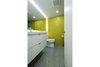 Modern home with Bath Room, Ceramic Tile Wall, Recessed Lighting, Engineered Quartz Counter, Enclosed Shower, Ceramic Tile Floor, Wall Mount Sink, Accent Lighting, and One Piece Toilet. View of Bathroom
Photo 18 of DC Waterfront Residence