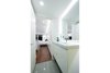 Modern home with Bath Room, Ceramic Tile Wall, Wall Mount Sink, Engineered Quartz Counter, Recessed Lighting, Accent Lighting, Ceramic Tile Floor, One Piece Toilet, and Enclosed Shower. View of Bathroom Photo 17 of DC Waterfront Residence