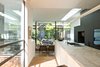 Modern home with Kitchen, Marble Counter, White Cabinet, Pendant Lighting, and Medium Hardwood Floor. Kitchen & Internal Courtyard Photo 6 of Residence K&S