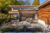 The lane house sits in the extensive gardens behind the primary residence. Sinking the ground floor 18" below grade allows for loftier ceilings while giving the patio a sense of enclosure. Photo 8 of 'Two Birds' Infill House modern home