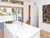 Modern home with Kitchen, White Cabinet, Medium Hardwood Floor, Engineered Quartz Counter, Recessed Lighting, and Undermount Sink. kitchen, entry, patio, and basement stairs Photo 2 of 8th and Slocan Laneway House