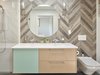 Modern home with Bath Room, Undermount Sink, One Piece Toilet, Porcelain Tile Wall, Enclosed Shower, and Porcelain Tile Floor. master bath with steam shower and herringbone tile Photo 5 of 8th and Slocan Laneway House