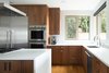 This kitchen boasts an island and a peninsula. Cabinets by Smith and Vallee Woodworks. Photo 5 of The Lakehouse modern home