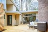Illumination house courtyard provides entrances to the main residence and a separate entrance to the in-law suite. Photo of Illumination House modern home