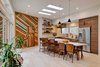 Modern home with Kitchen, Refrigerator, Pendant Lighting, Range, Wood Cabinet, Drop In Sink, Range Hood, Recessed Lighting, Dishwasher, and Open Cabinet. The kitchen features a reclaimed wood installation by artist Blake Sloane from Hyattsville, MD. Photo 5 of Illumination House