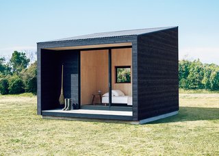 Burnt cedar, Japanese cypress plywood, and mortar create a trio of contrasting yet simple surface textures that breathe a relaxed vibe into the Muji Hut.