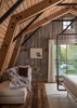 Modern home with Bedroom, Rug Floor, Bed, and Medium Hardwood Floor. This living/bedroom space showcases neutral tones and shades of white to contrast the continued use of natural, treated wood surfaces. Photo 3 of The Barn