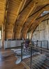 Modern home with Kitchen, Wood Cabinet, Medium Hardwood Floor, Pendant Lighting, and Track Lighting. A small dining space and kitchen area blend into the expansive wood paneling used throughout The Barn. Photo 4 of The Barn