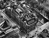 An aerial view of the bank before an expansion in 1927.
The building was originally designed by F.W.M. Poggenbeek in 1908 and was expanded in phases until 1932. The layout follows what would be expected for a bank with vaults on the ground floor and basement, a monumental bank hall on the first floor, and office space located on the upper floors. Photo 2 of W Amsterdam modern home