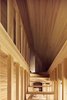 The open staircase is seen from a front angle, showcasing the dynamic lines that converge at the top of the stairway leading to the bedroom space. Photo 9 of Yoshino Cedar House modern home