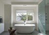 Modern home with Bath Room, Porcelain Tile Floor, Drop In Sink, Freestanding Tub, Engineered Quartz Counter, Open Shower, Recessed Lighting, Accent Lighting, Porcelain Tile Wall, and One Piece Toilet. Bathroom detail Photo 10 of The River House