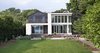 Modern home with Outdoor, Back Yard, Trees, Hardscapes, Walkways, Decking Patio, Porch, Deck, Gardens, Pavers Patio, Porch, Deck, Stone Patio, Porch, Deck, Metal Patio, Porch, Deck, and Metal Fences, Wall. Exterior view from the river Photo of The River House